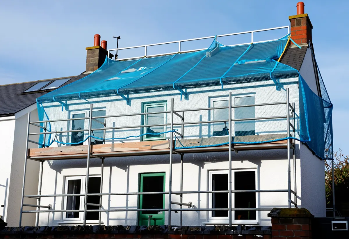 Scaffolding around a two storey house during a full roof replacement